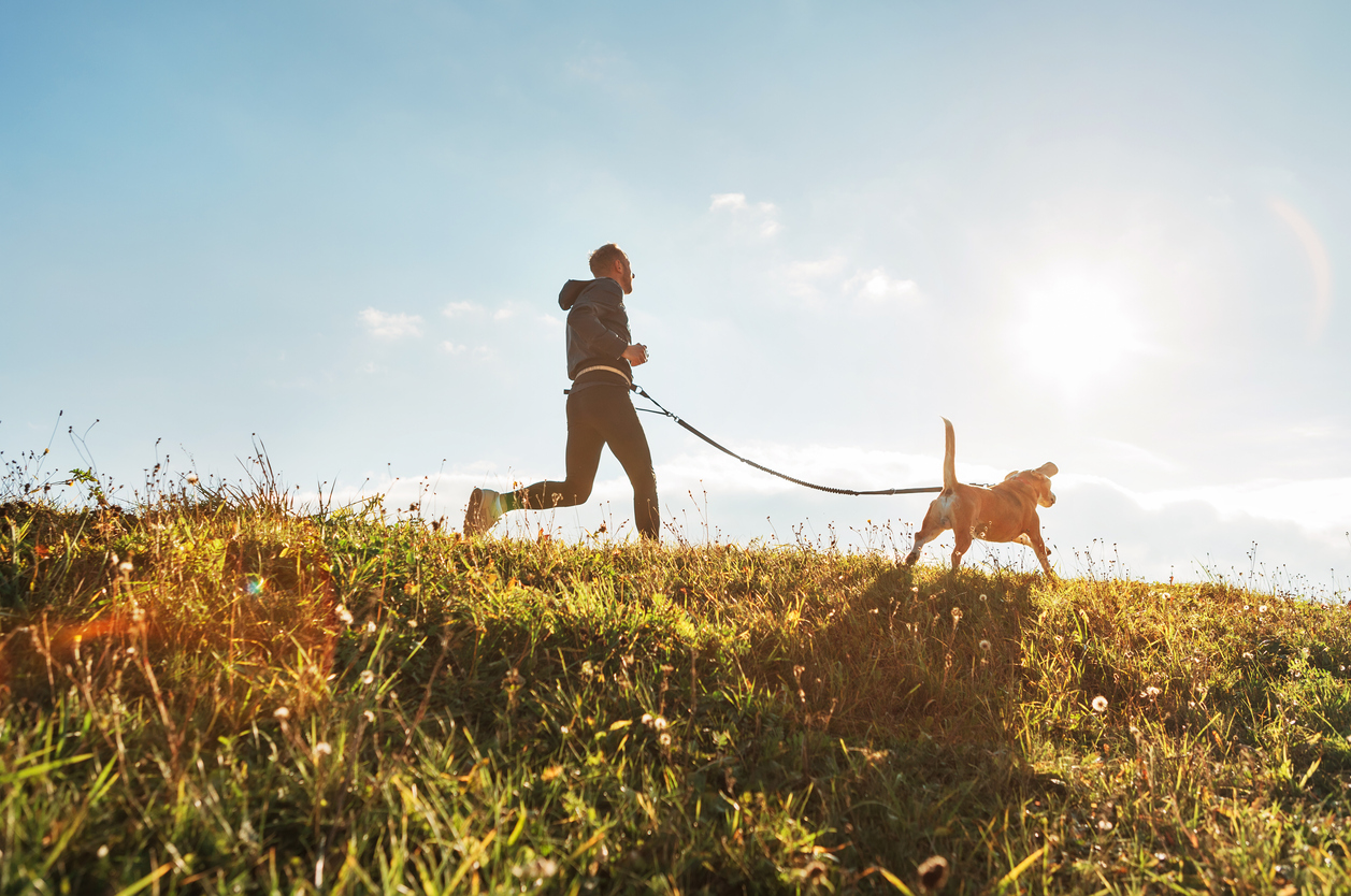 man running with dog