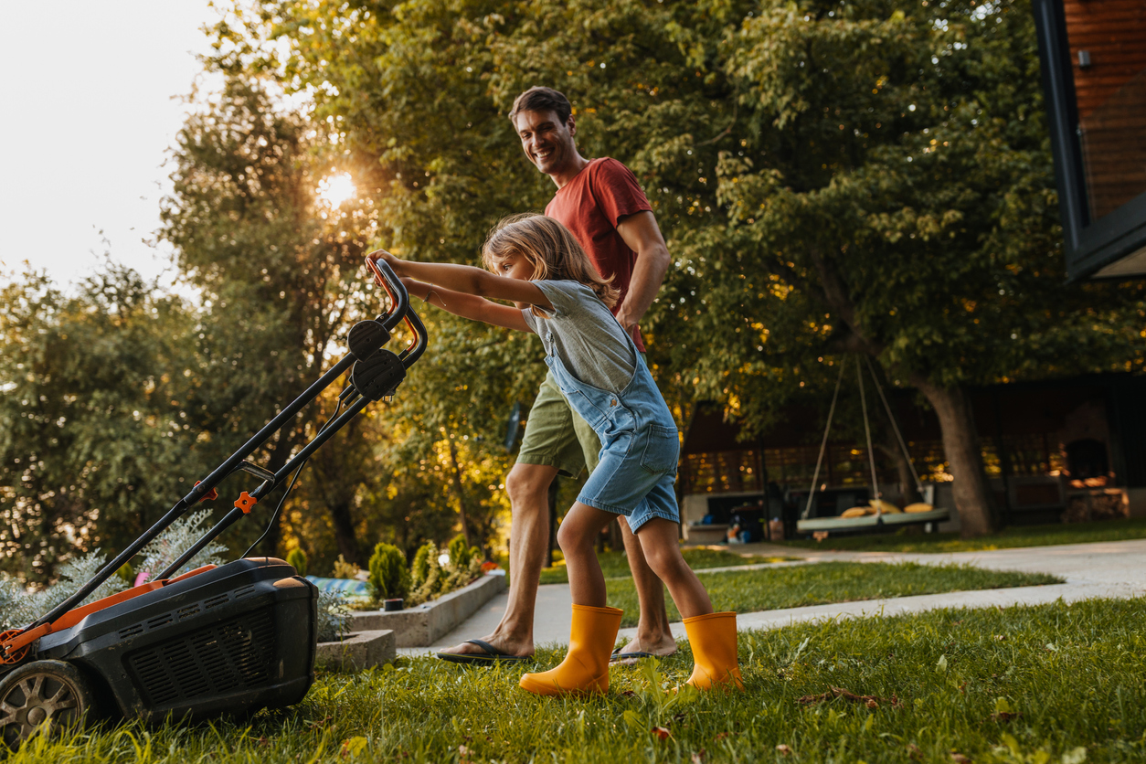 family mowing lawn