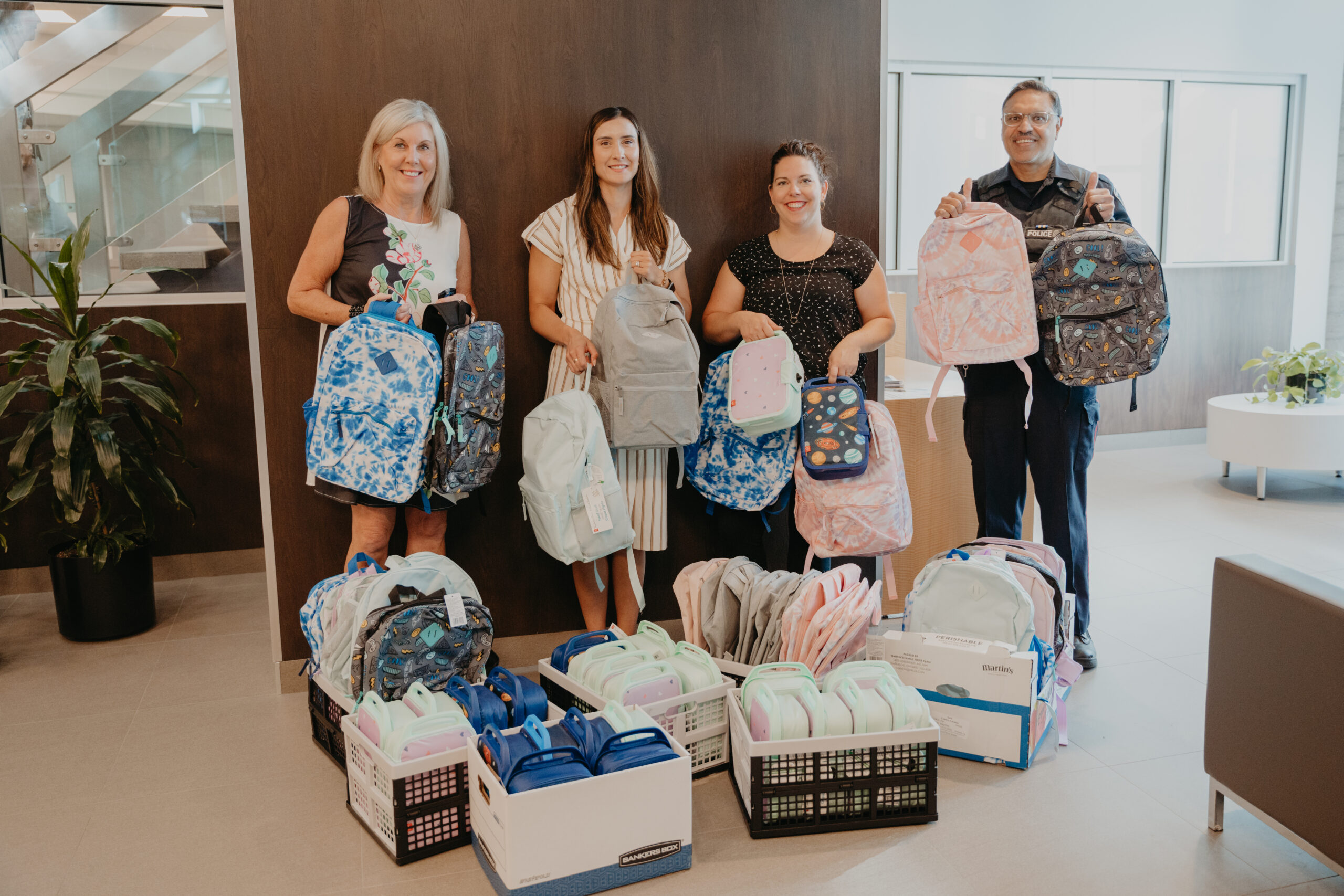 Backpack donation at WRPS headquarters with staff